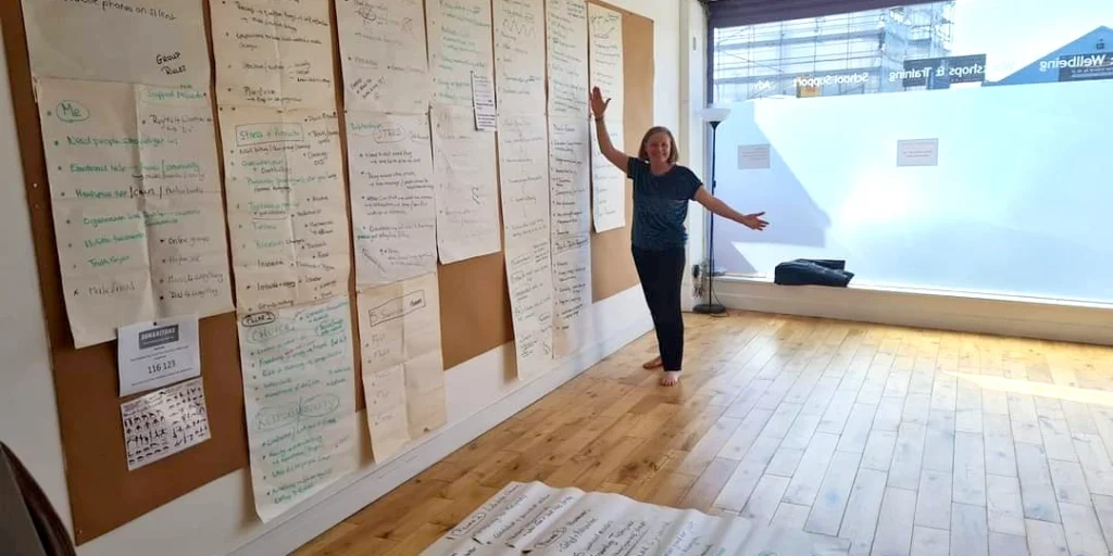 Chris Tuck, Motivational Speaker and Trainer, standing in her training room delivering her training programmes