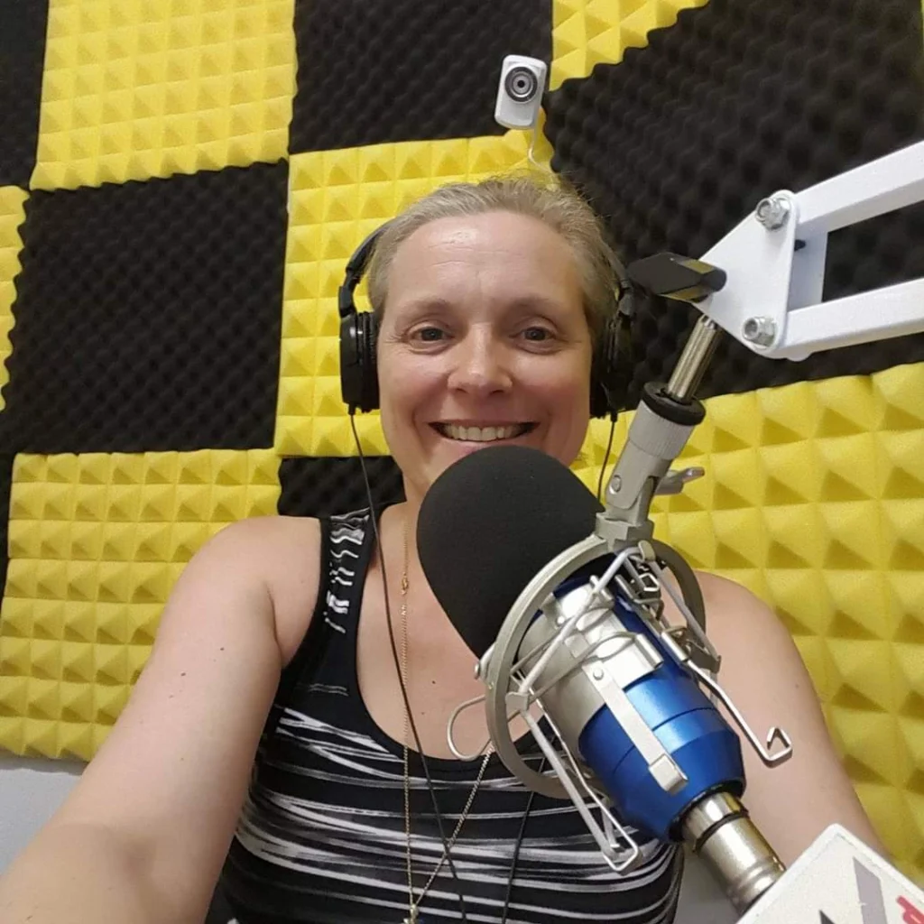 Chris Tuck speaking into a microphone for podcast.