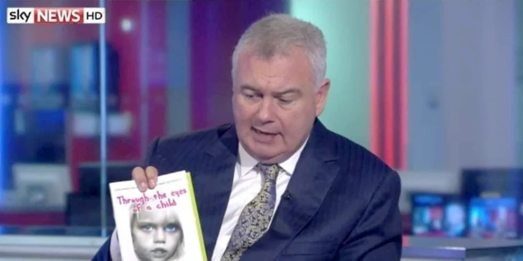 Eamon Holmes on Sky news holding a book, Through the eyes of a child by Chris Tuck, Author