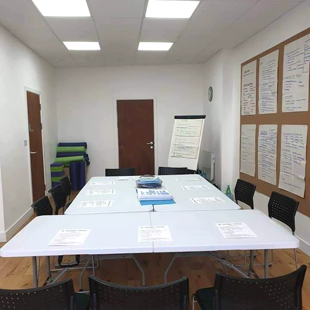 Training programmes room set up for workshops with seats around a table.